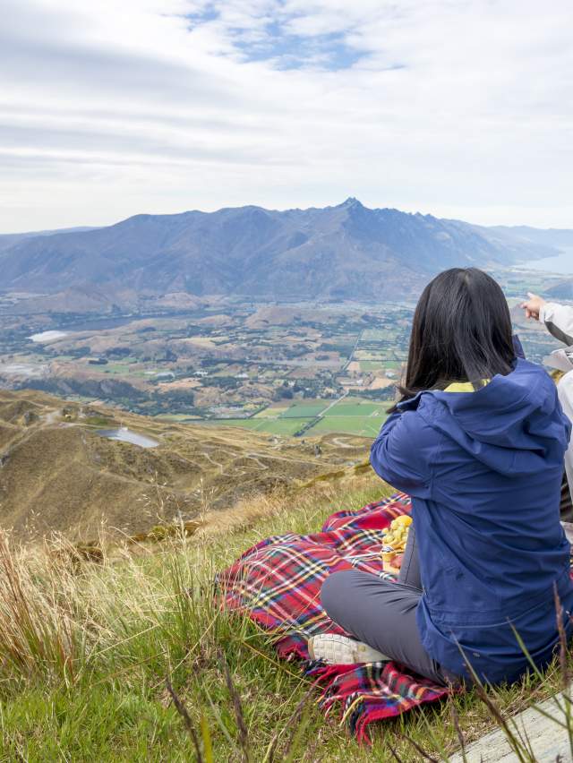 Sightseeing from Coronet Peak in summer with a picnic