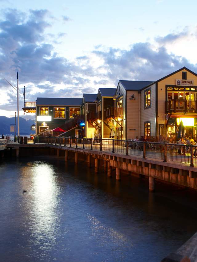 Steamer Wharf eateries at night, Queenstown Bay at dusk