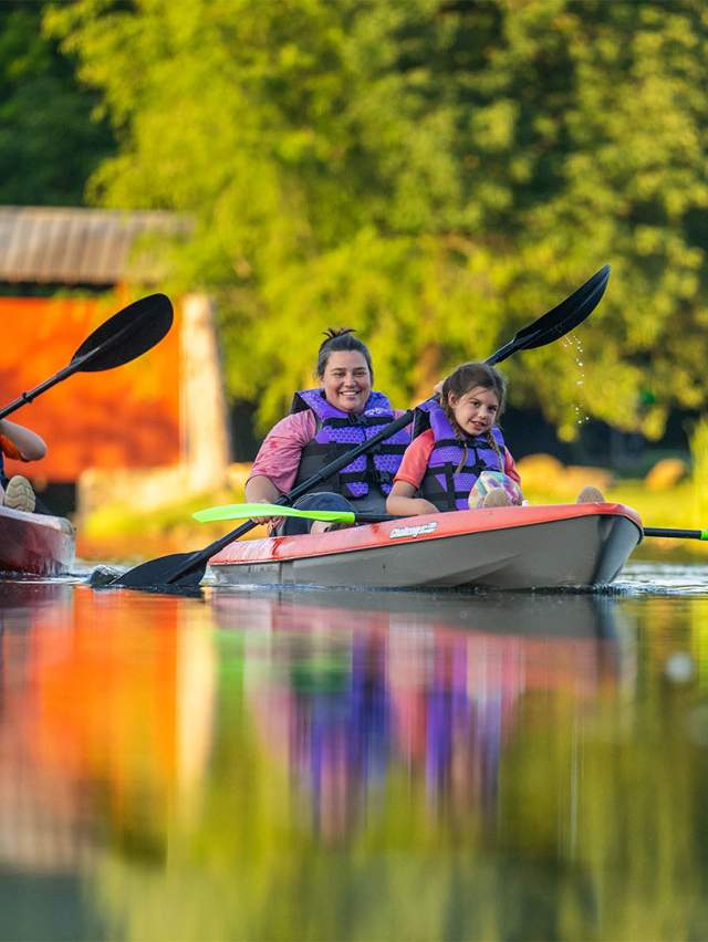 A family of 3 kayaking in Fowler Park, Terre Haute, Indiana