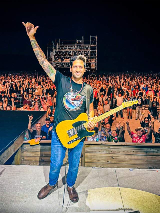 Musician with guitar in front of crowd at The Mill in Terre Haute, Indiana