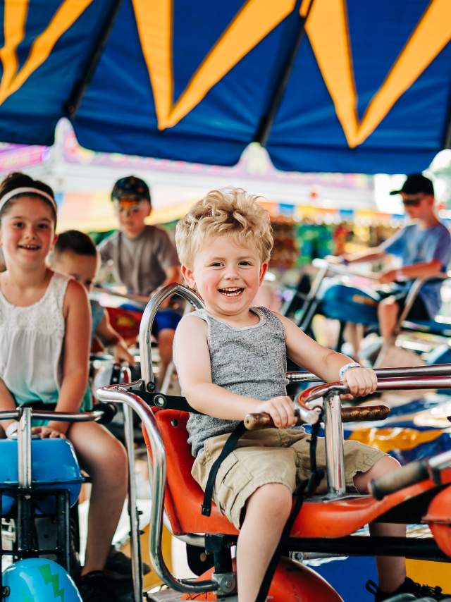 A child rides on a merry-go-round at the Allegany County Fair.