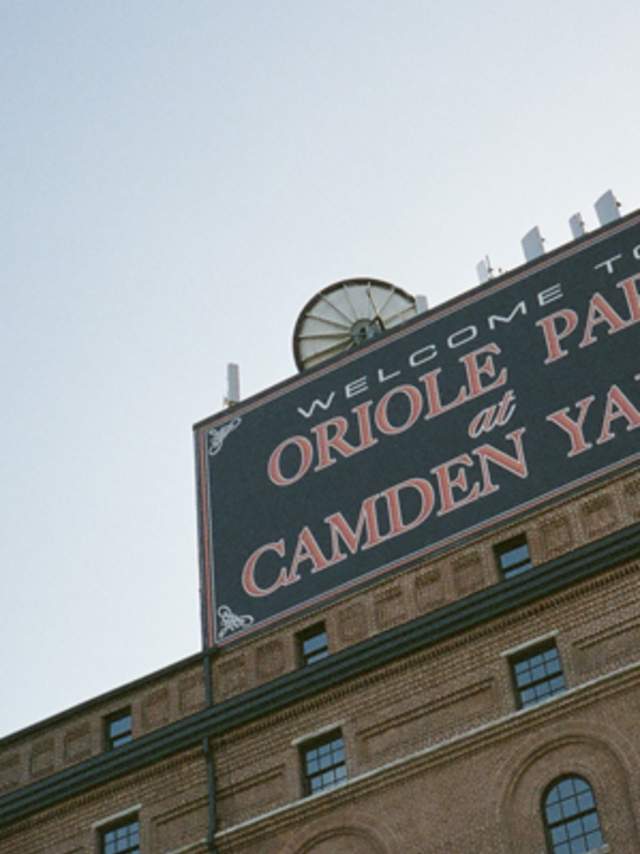 Welcome to Oriole Park at Camden Yards sign that sits on the top of the brick building as an entrance to Camden Yards ballpark.