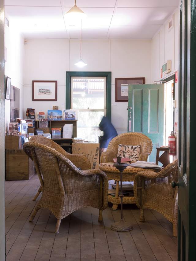 Interior view of Dalgety House Museum Port Hedland, showing seating, a table and some of the history displays