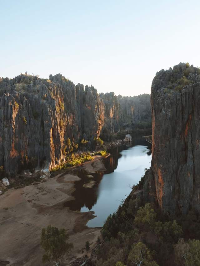 An aerial view of Windjana Gorge, showing the scale of the cliff faces with water visible in the base of the gorge.