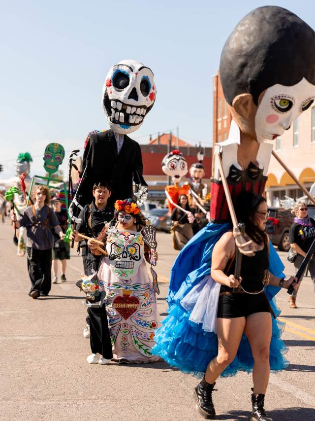mojigangas—towering, larger-than-life puppets in the Dia de los Muertos parade