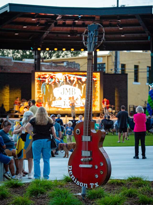 Big Red Guitar Sculpture in front of Heritage Park that says Denison, TX