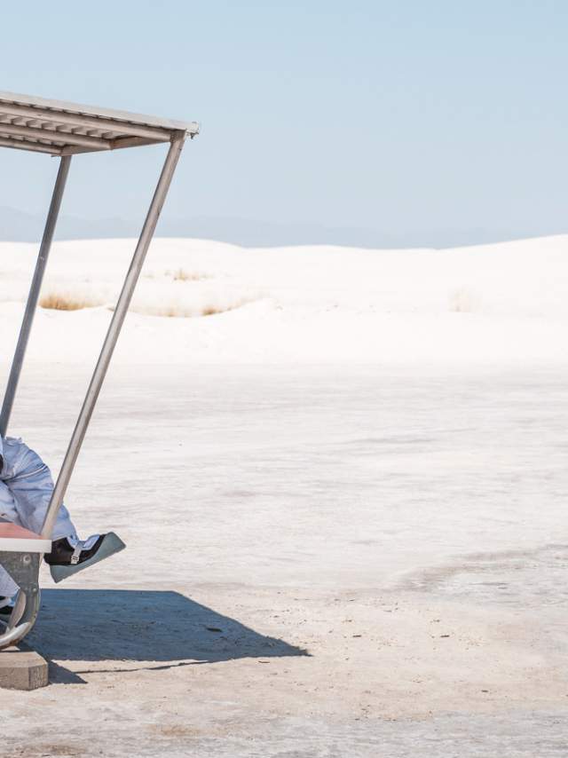 An astronaut relaxing and taking in the view at White Sands Nat'l Park