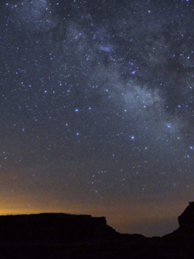 The Milky Way lights the night sky over Chaco Canyon at night.