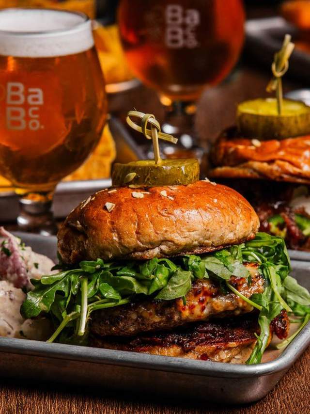 A juicy hamburger with beer in a glass