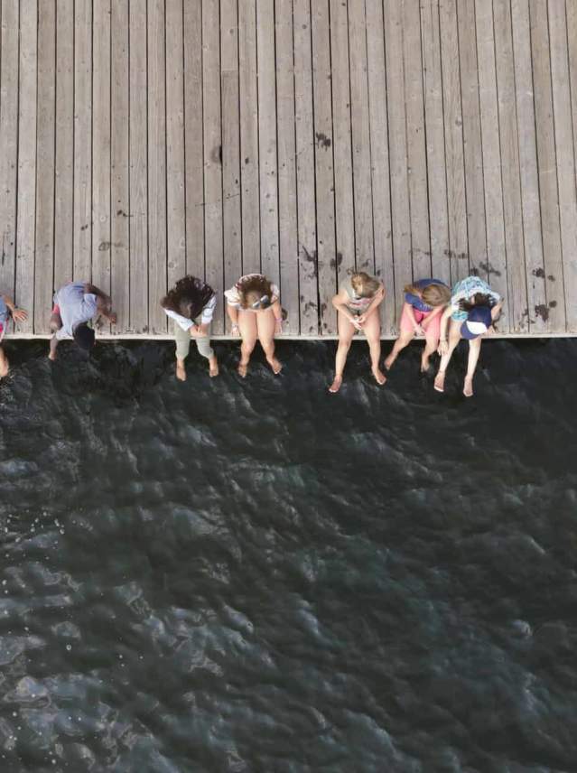overhead view of people sitting on dock