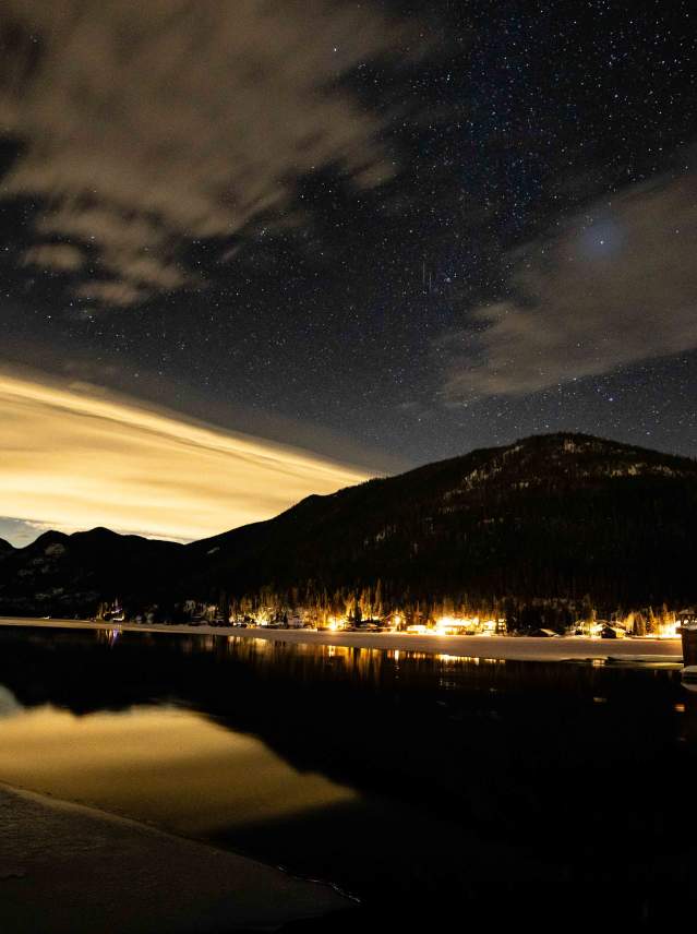 View of Grand Lake and the night sky showing Mount Baldy, the lake and stars