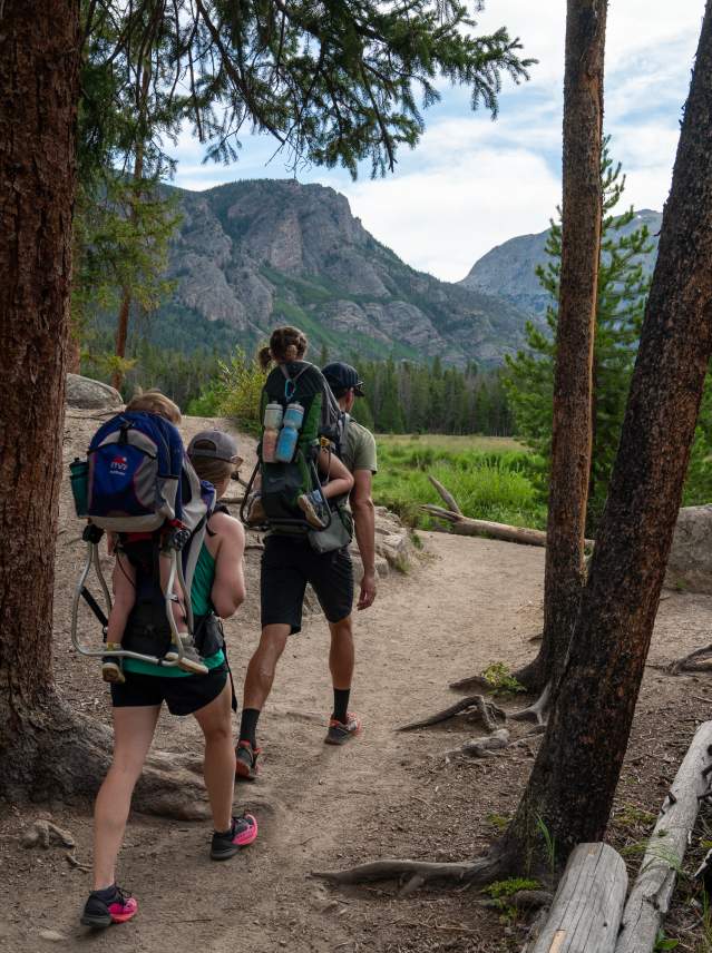 Family hiking the east inlet trail with mount baldy in the background