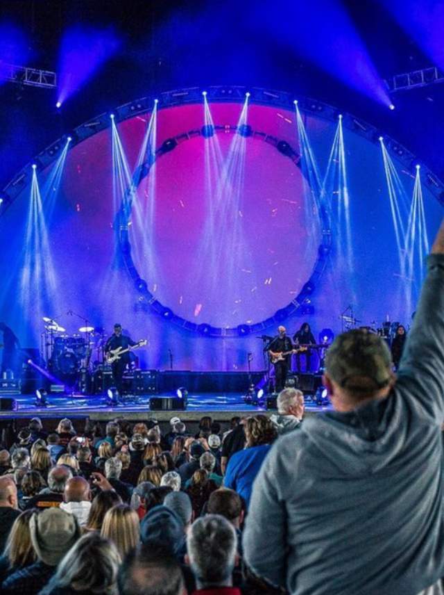 An audience member stands during a concert at Rose Music Center
