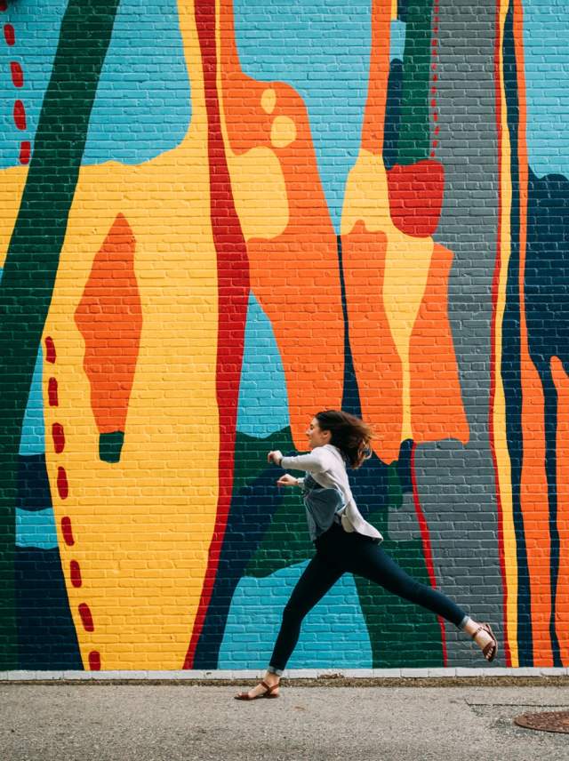 Woman in front a mural
