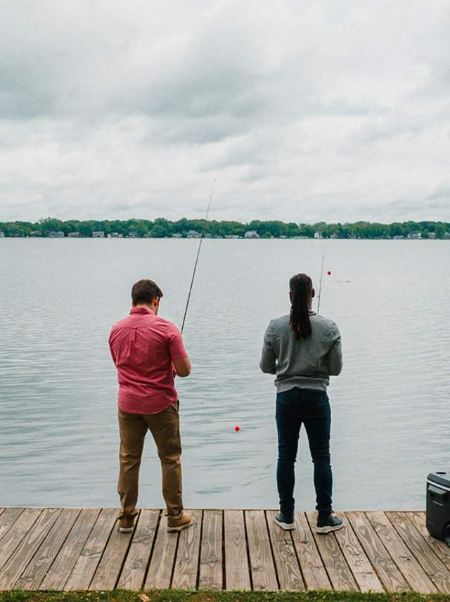 Two men fish off the pier of Lakeview Park.