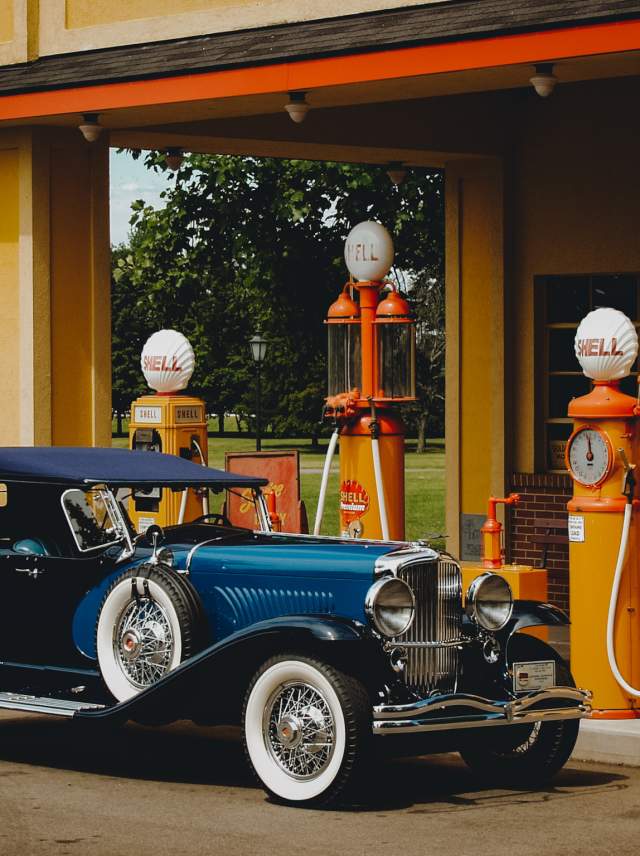 Classic car in front of historic gas station