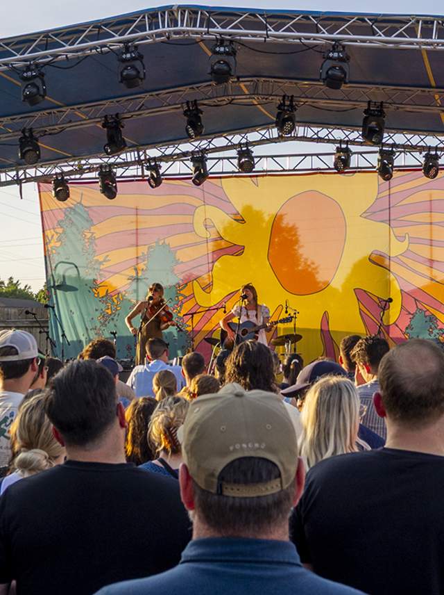 Three young women perform on stage at the Bell's Brewery Summer Concert Series in Kalamazoo, MI.