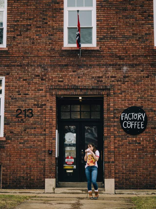 Woman standing outside the Factory Coffee building