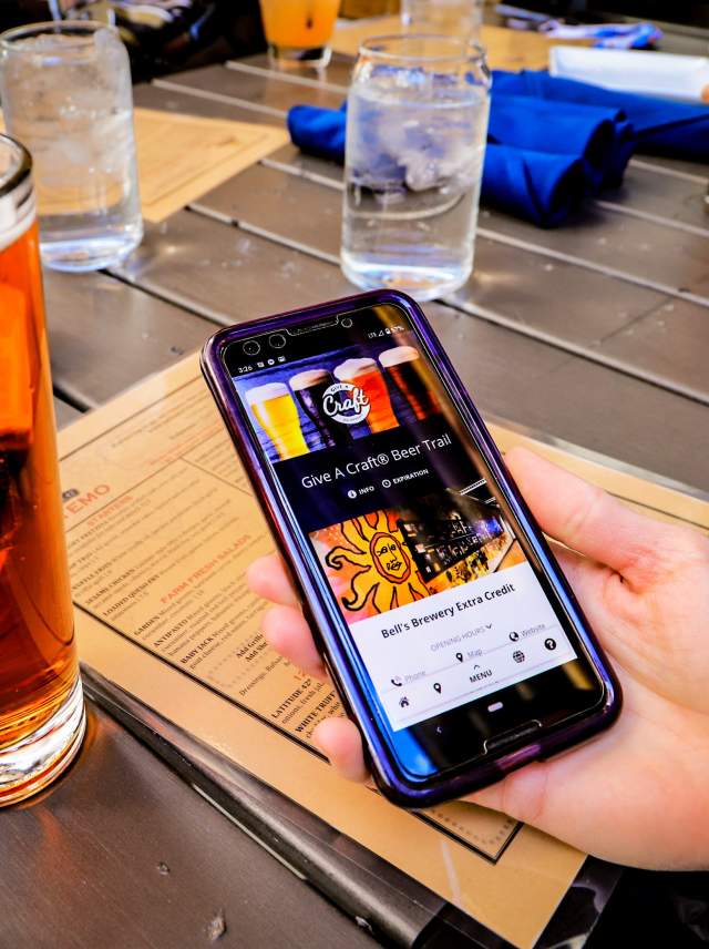 A cell phone with the Give A Craft® Beer Trail passport on screen