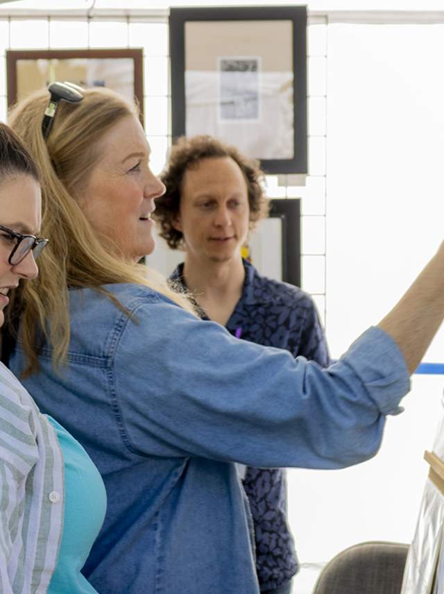 Two women admire local artist works at the KIA Art Fair during JumpstART Weekend.