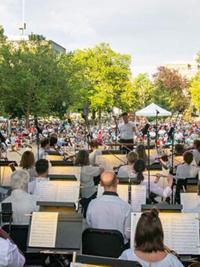The Kalamazoo Symphony Orchestra performs on stage at Bronson Park during Patriotic Pops, a concert celebrating patriotic tunes.