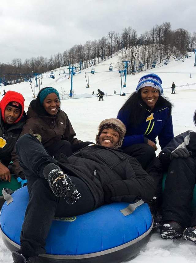 group of people tubing in snow