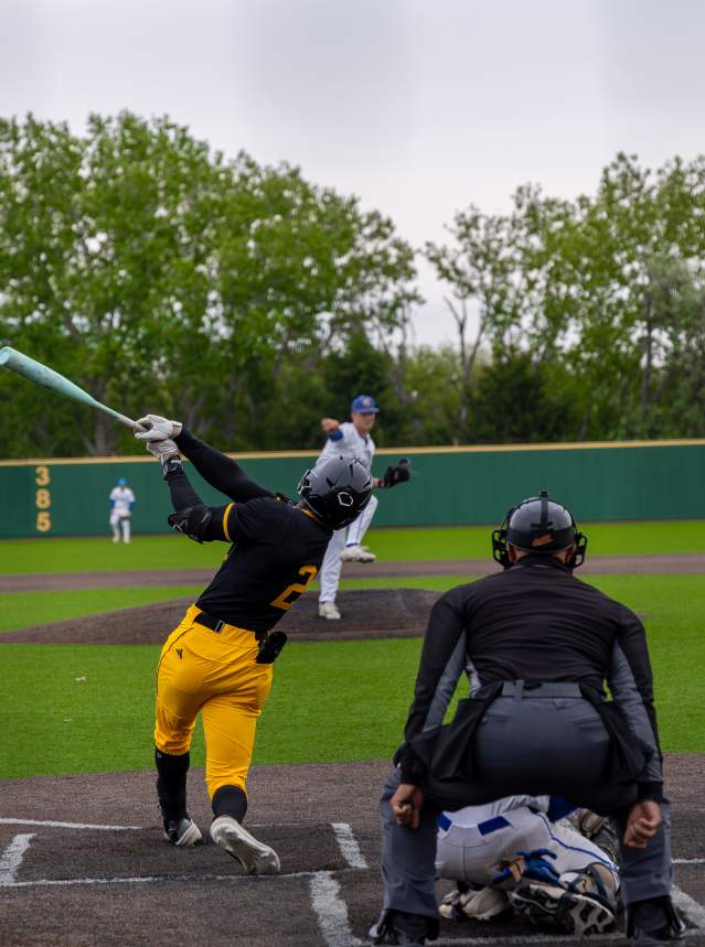 A batter swings at a pitch during a game.