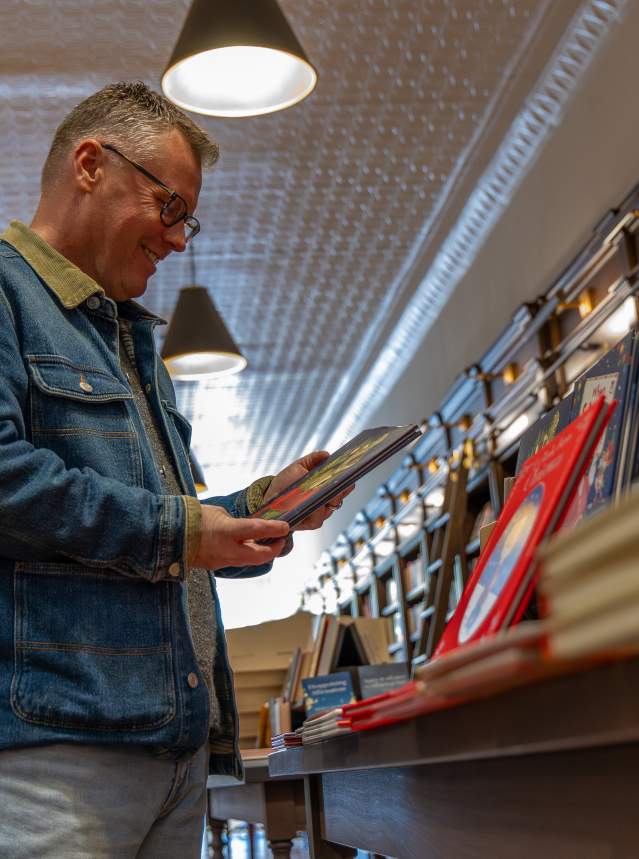 Man looking at book in bookshop