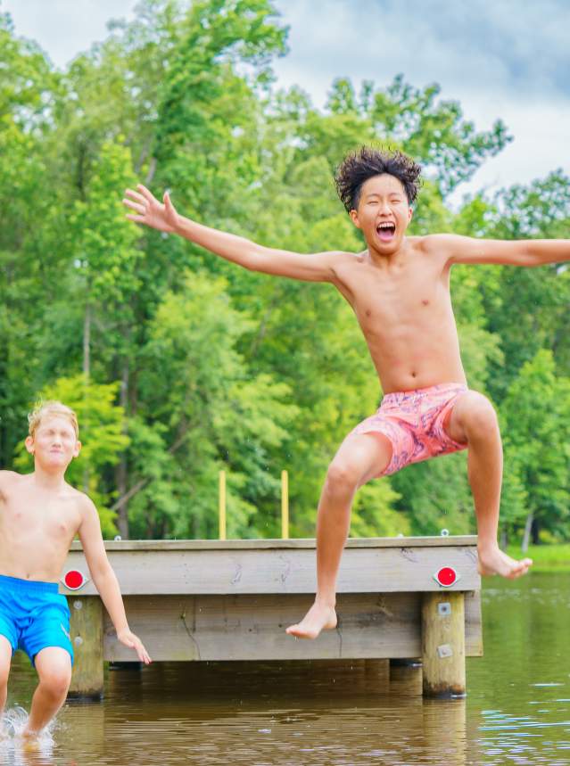 Two Boys Jumping Off a Pier at Cypress Black Bayou