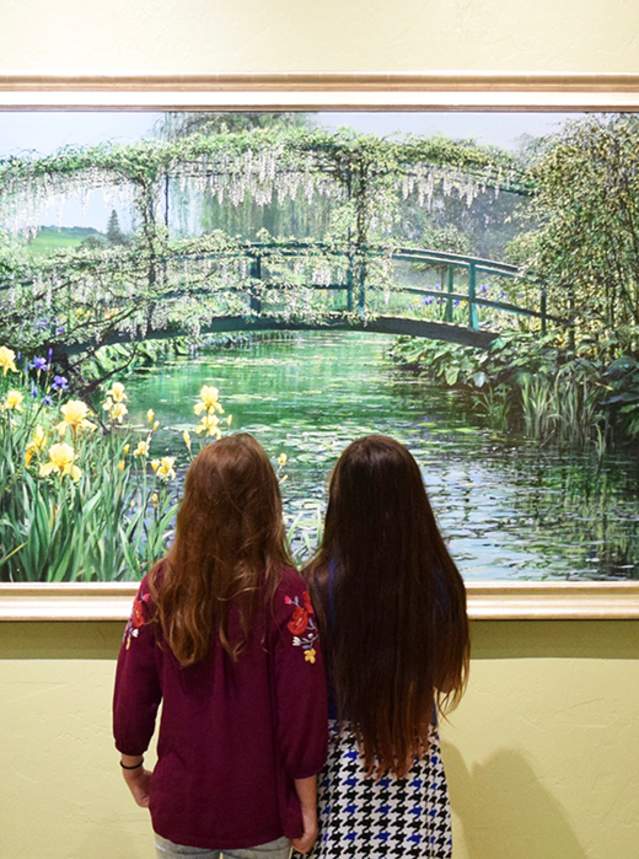Two girls looking at a painting at R.W. Norton Art Gallery