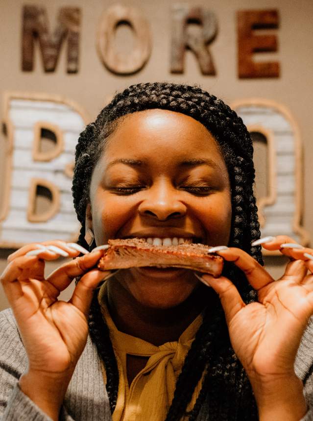 Woman eating smoked ribs at Real BBQ & More in Shreveport, La.