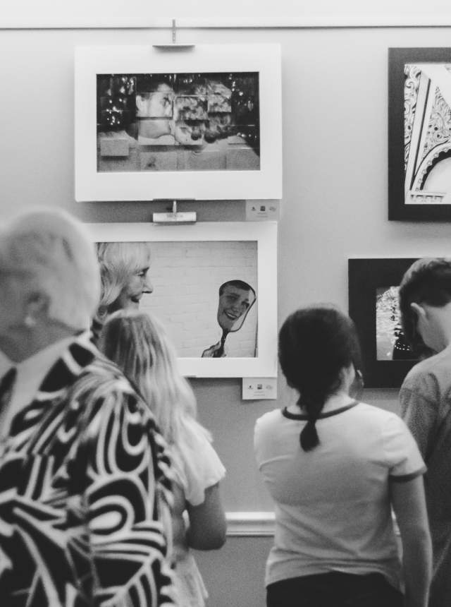 Guests take in the pieces at an art show