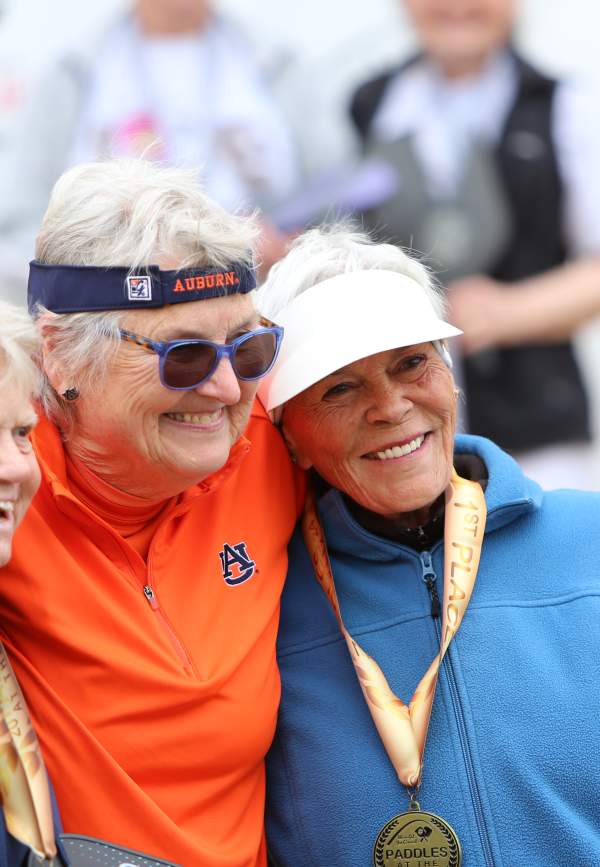 three women at posing for photo at pickleball medal ceremony