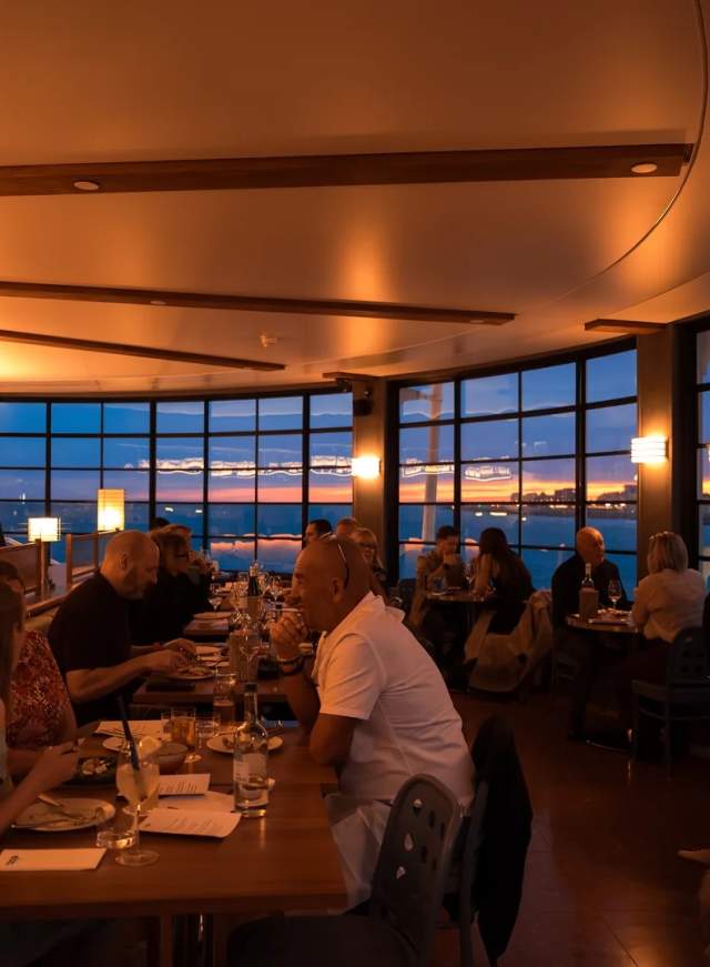 Diners enjoying food and sea views at Ebb restaurant on Worthing Pier