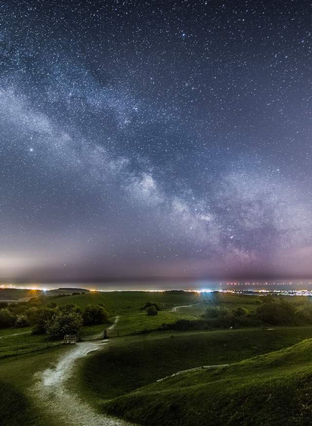 Beautiful night time landscape of the South Downs with star constellations in the night sky
