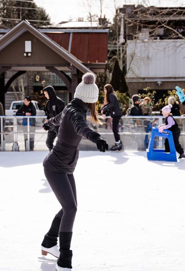 Woman ice skating on an ice skating rink in Highlands, North Carolina.