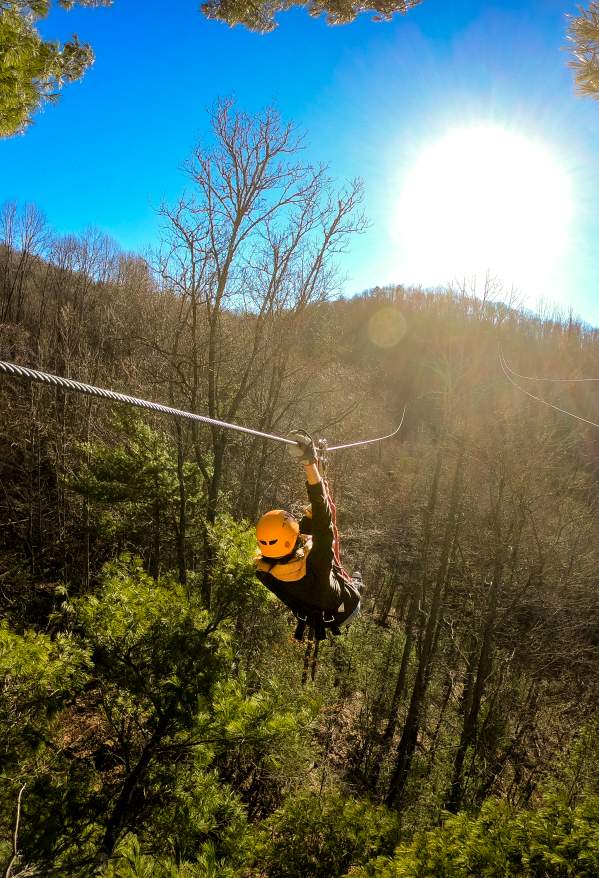 Person ziplining in the mountains in Highlands, North Carolina