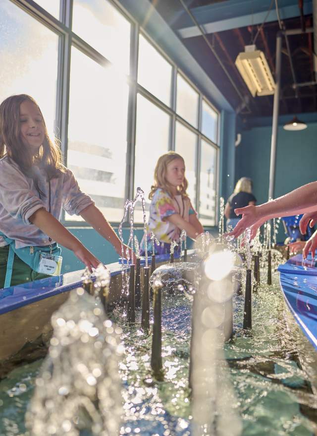 Girls playing in water at Impression 5 Science Museum