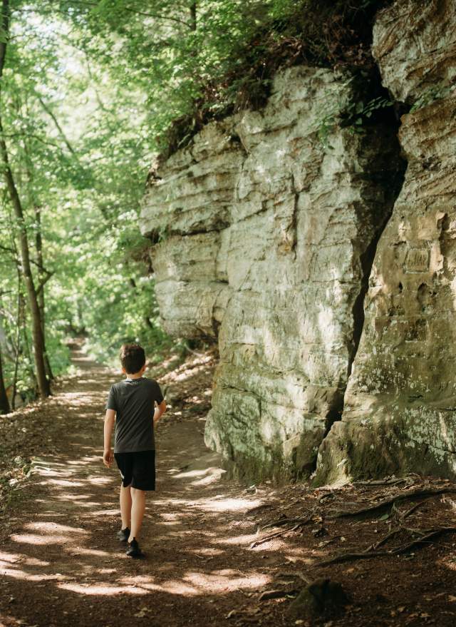 Young kid walking along the trail next to the Ledges at Fitzgerald Park