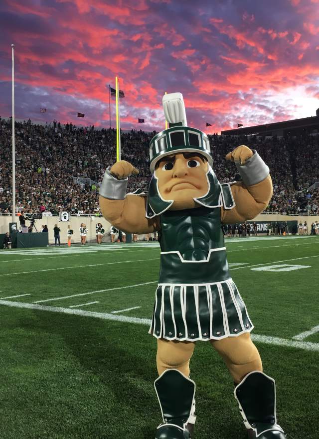 Michigan State University's Mascot, Sparty, standing on the turf of Spartan Field.