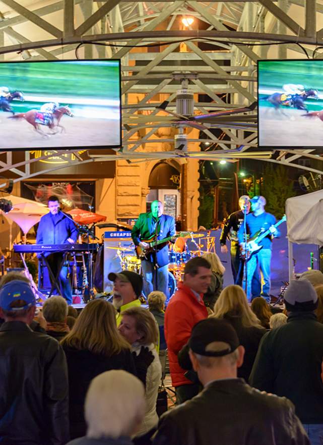 People enjoying live music and horse races at the Breeders' Cup Festival
