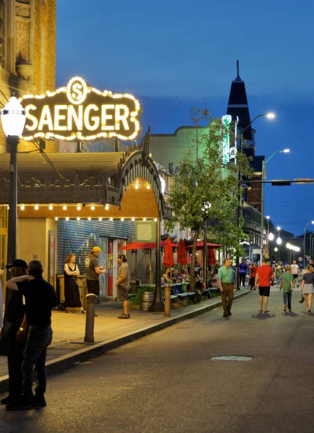 night time street view of the Saenger theatre with lighted, covered entrance