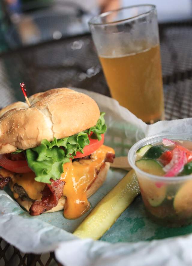 Bacon Cheeseburger, pickle spear, cup of tomato and cucumber salad
