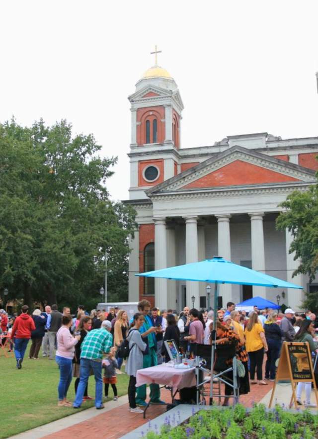 Cathedral Square: park with crowd of people in front of a large church