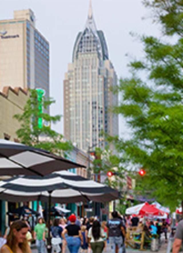 street view of downtown Mobile with skyscrapers in the distance