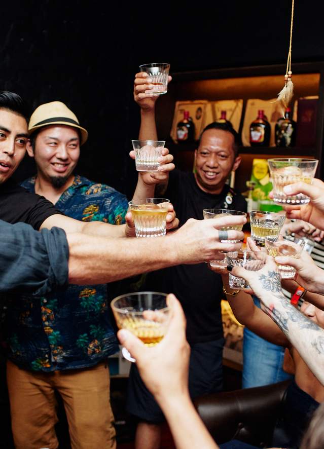 Several people clink glasses at Tales of the Cocktail event in 2023