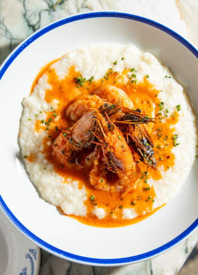 A plate of Shrimp and Grits sits on the table at Seaworthy, an upscale seafood restaurant in New Orleans.