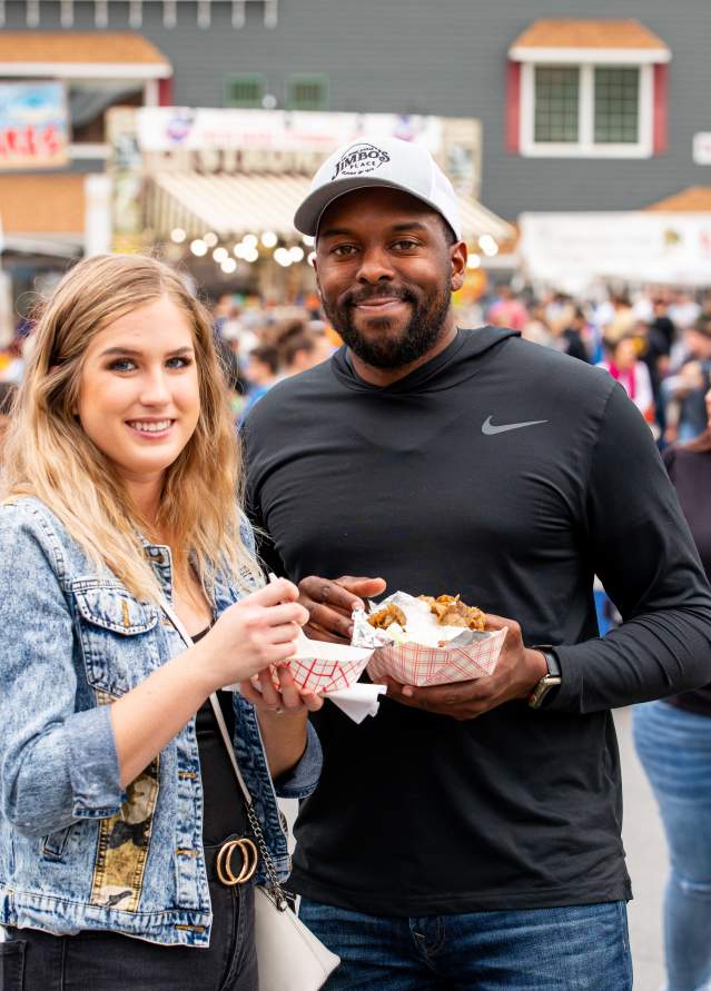 Couple stands with food at Fort Ligonier Days