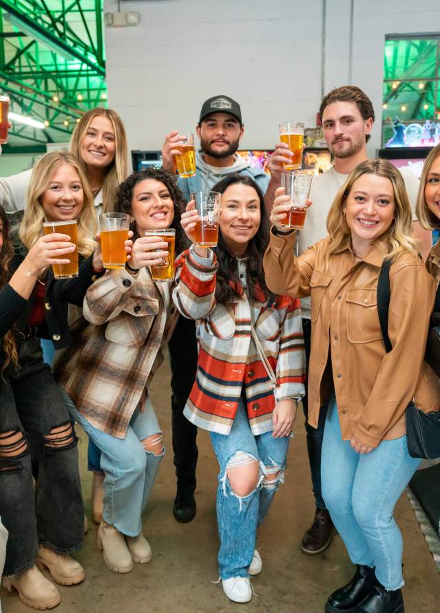 Group raising their glass for a toast to the Pour Tour