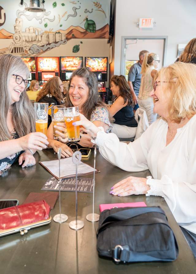 Pour Tourers cheers their drinks at Picks & Pours Draft Party